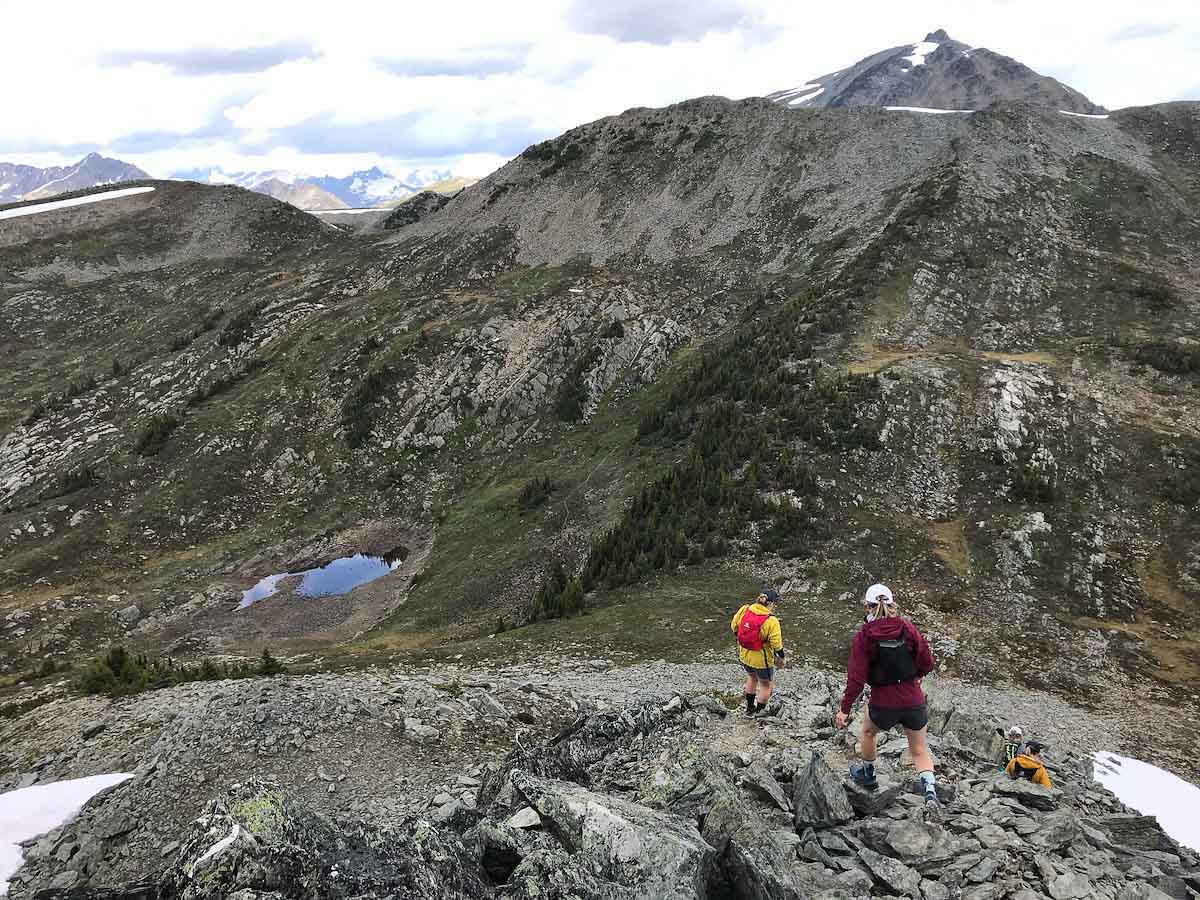 Best Running Hats of 2021 Best Running Hats - trail runners wearing hats on rocky scramble