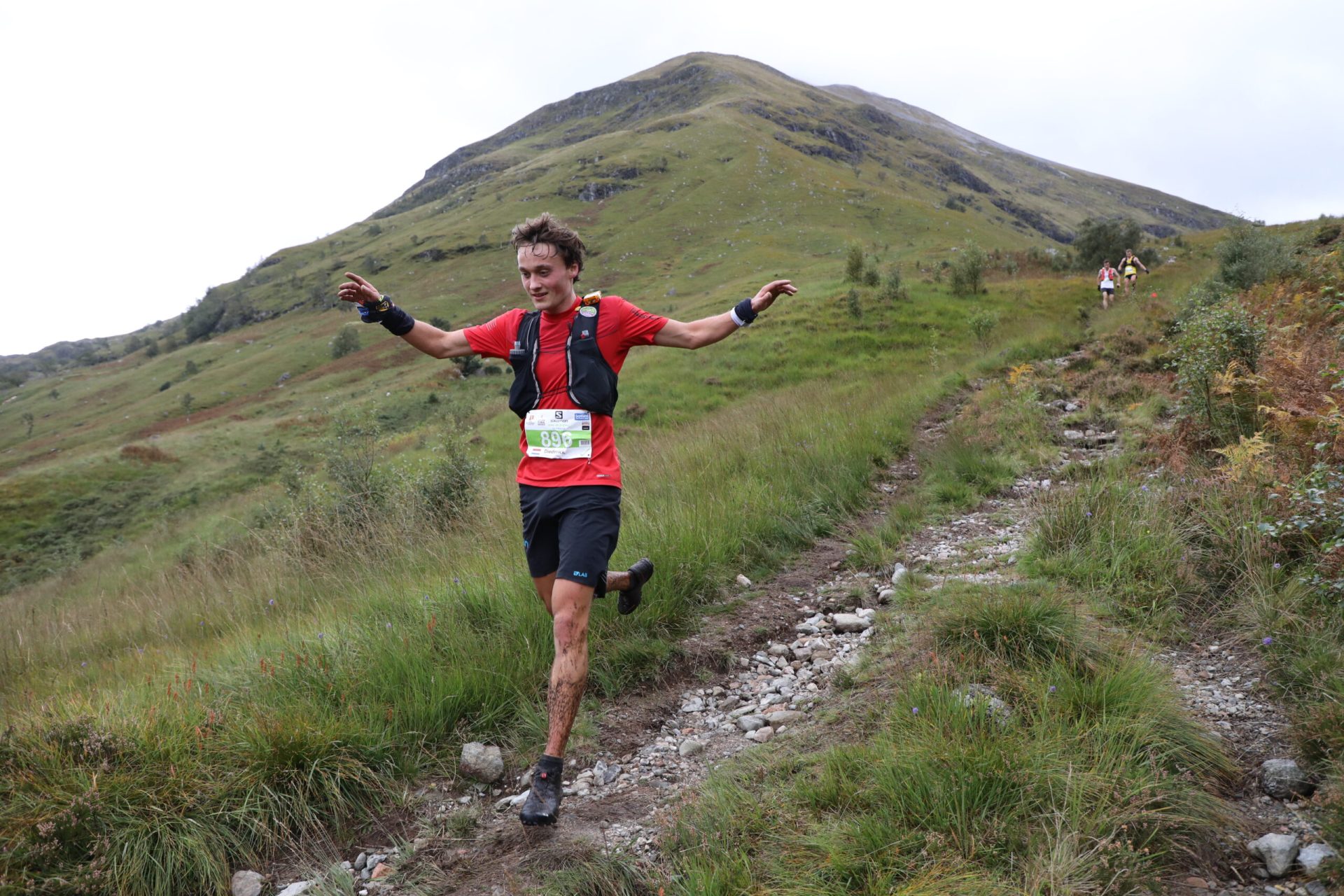 A runner descending on a rainy day during the Ring of Steall Skyrace.